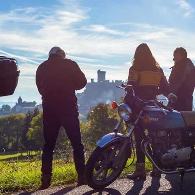 Biker friends on the bass side to contemplate the view of the Polignac fortress in Haute-Loire