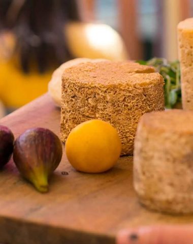 A platter of Haute-Loire cheeses, served with figs and plums