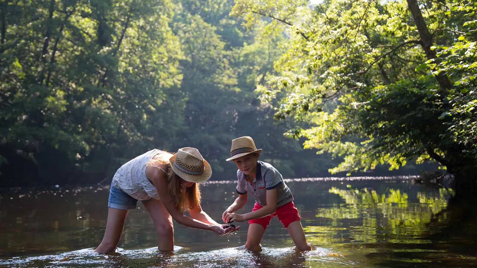 A mother and son plays in the river in Haute-Loire, Auvergne