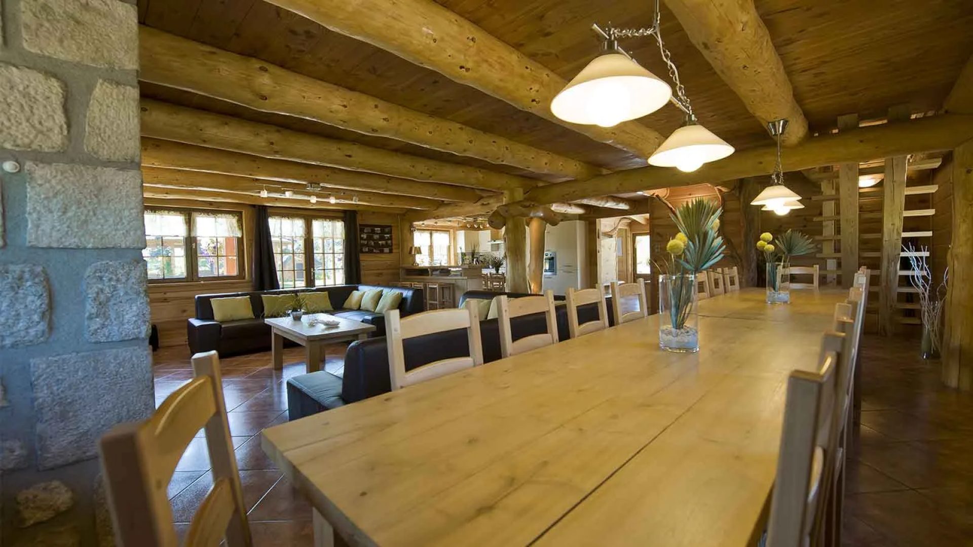 The large dining table and living room of a large capacity accommodation in Haute-Loire, Auvergne