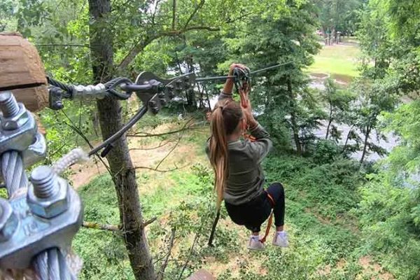 A child on the Saint Gal Parc zip line which passes over the Allier in Haute-Loire, Auvergne