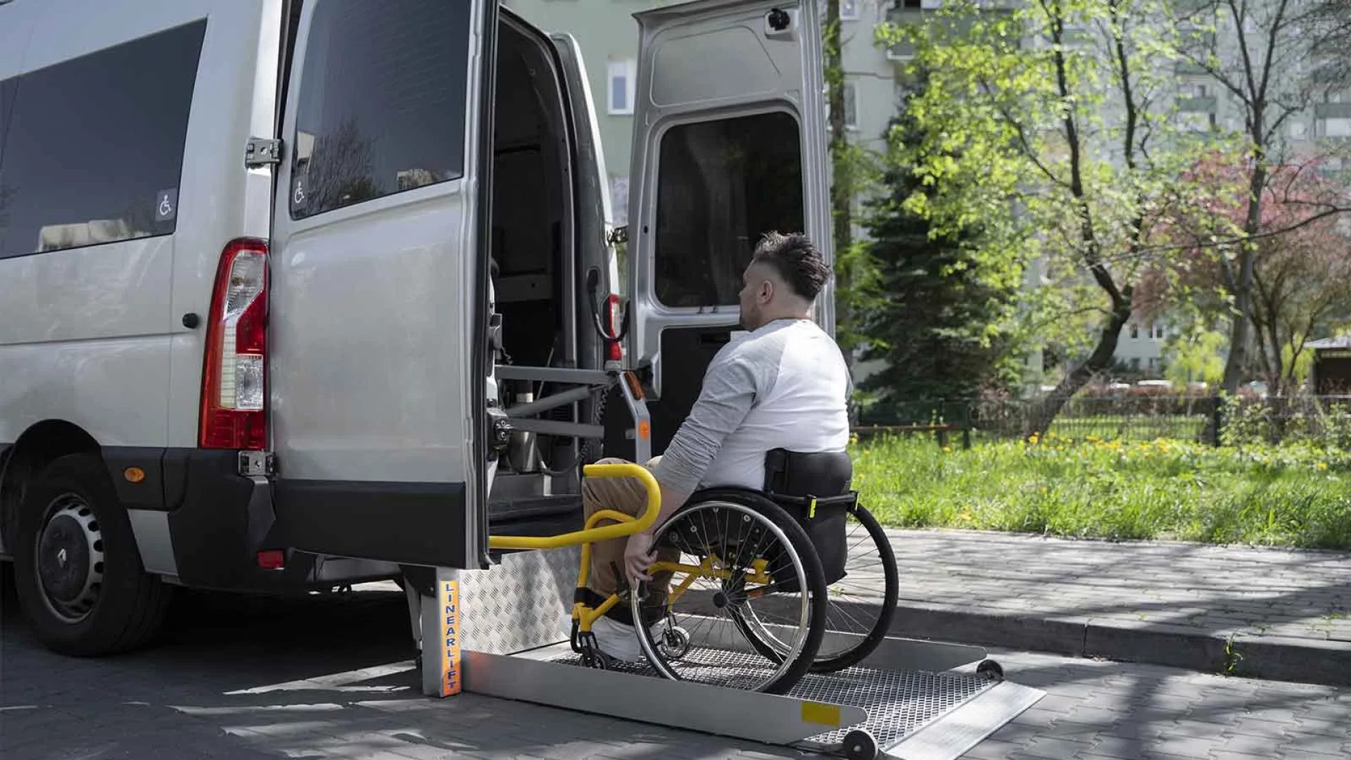 Homme en fauteuil roulant qui monte dans véhicule adapté en Haute-Loire, Auvergne