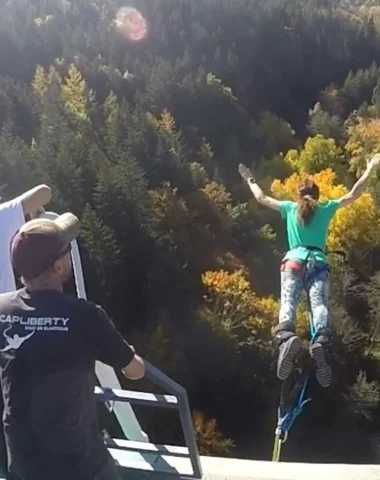 Woman bungee jumping from the Recoumène viaduct in Haute-Loire